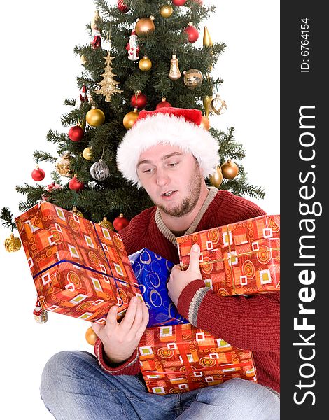 Happy man with gifts over christmas tree. Happy man with gifts over christmas tree