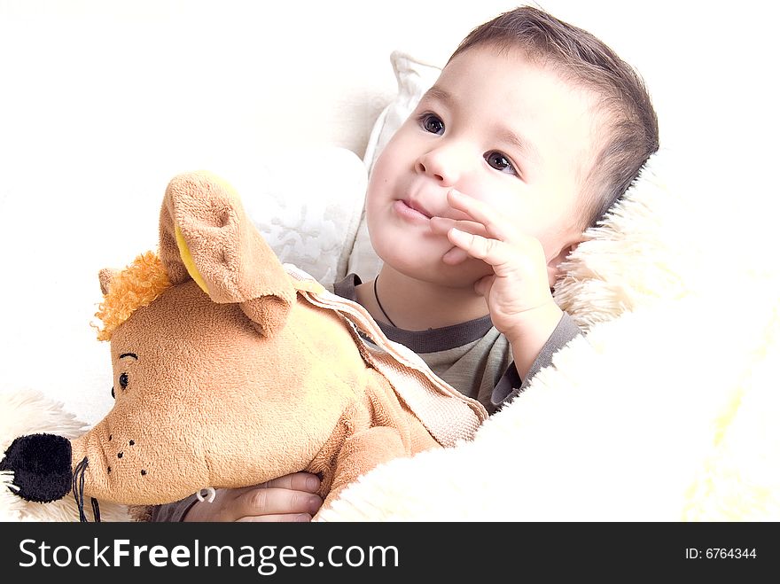 Portrait of a little happy kid with toys