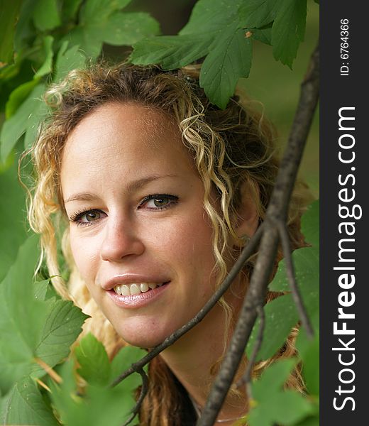 Curly girl face detail surrounded by maple leaves