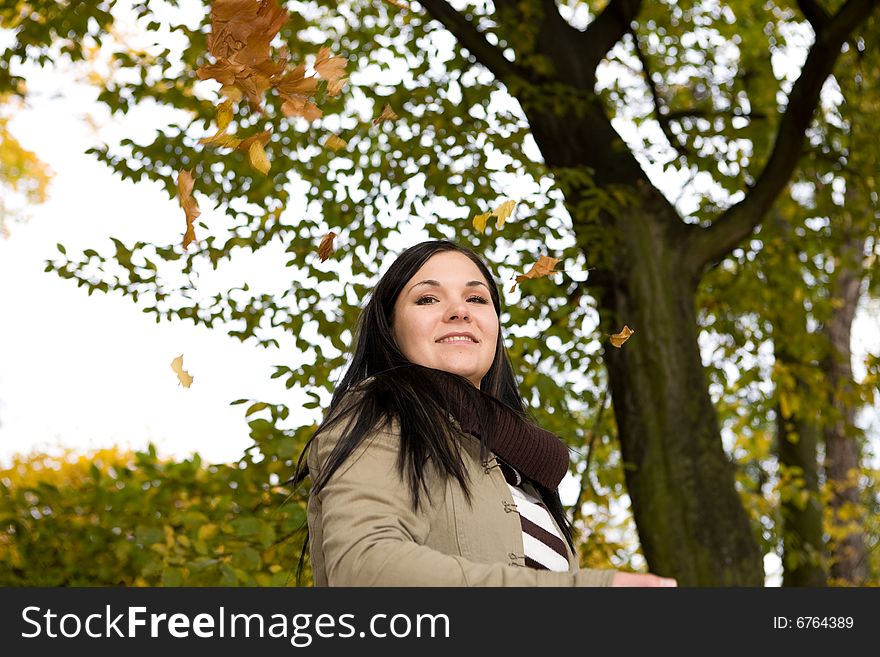 Happy brunette woman relaxing in park. Happy brunette woman relaxing in park