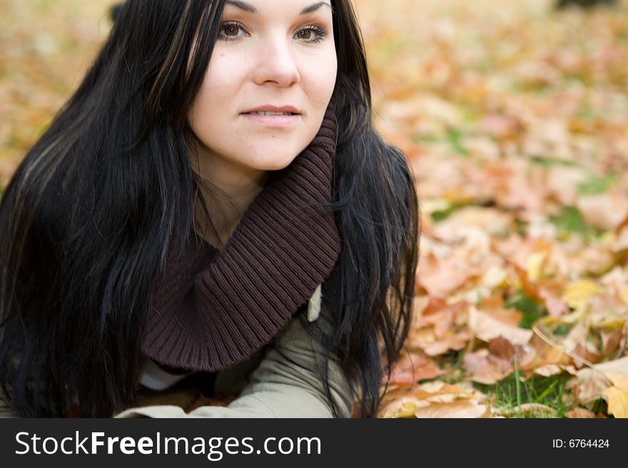 Happy brunette woman relaxing in park. Happy brunette woman relaxing in park