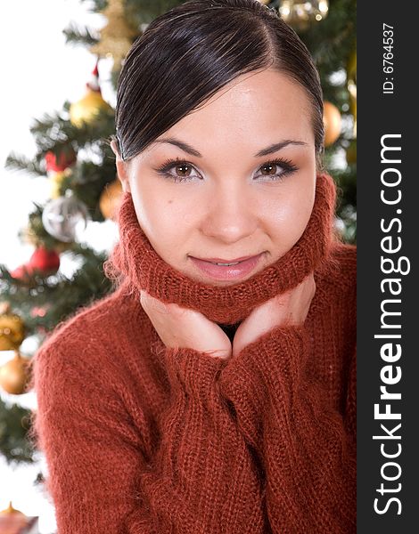 Happy brunette woman over christmas tree. Happy brunette woman over christmas tree