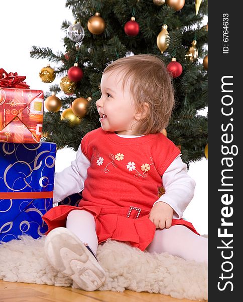 Cute baby girl over christmas tree. Cute baby girl over christmas tree