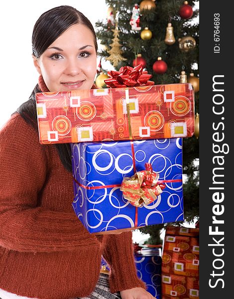 Happy brunette woman over christmas tree. Happy brunette woman over christmas tree