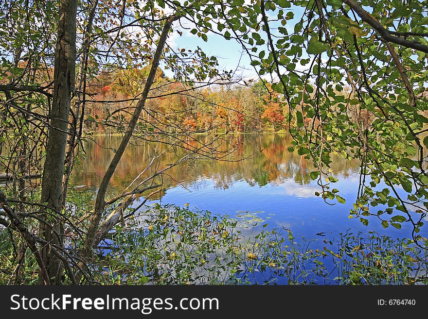 Fall trees relecting on sand lake in Chain O' Lakes State Park, Indiana. Fall trees relecting on sand lake in Chain O' Lakes State Park, Indiana