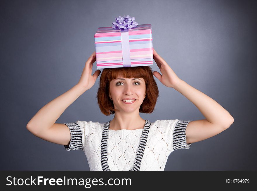 The beautiful Girl with a box of gifts on a head