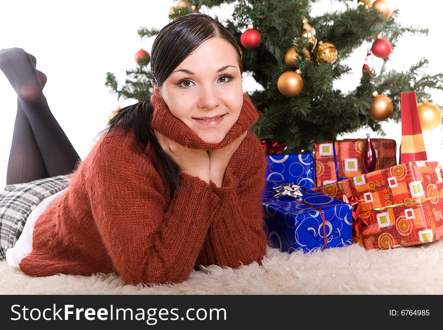 Happy brunette woman over christmas tree. Happy brunette woman over christmas tree