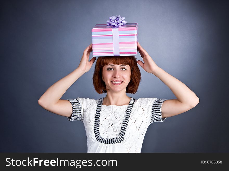 The beautiful Girl with a box of gifts on a head