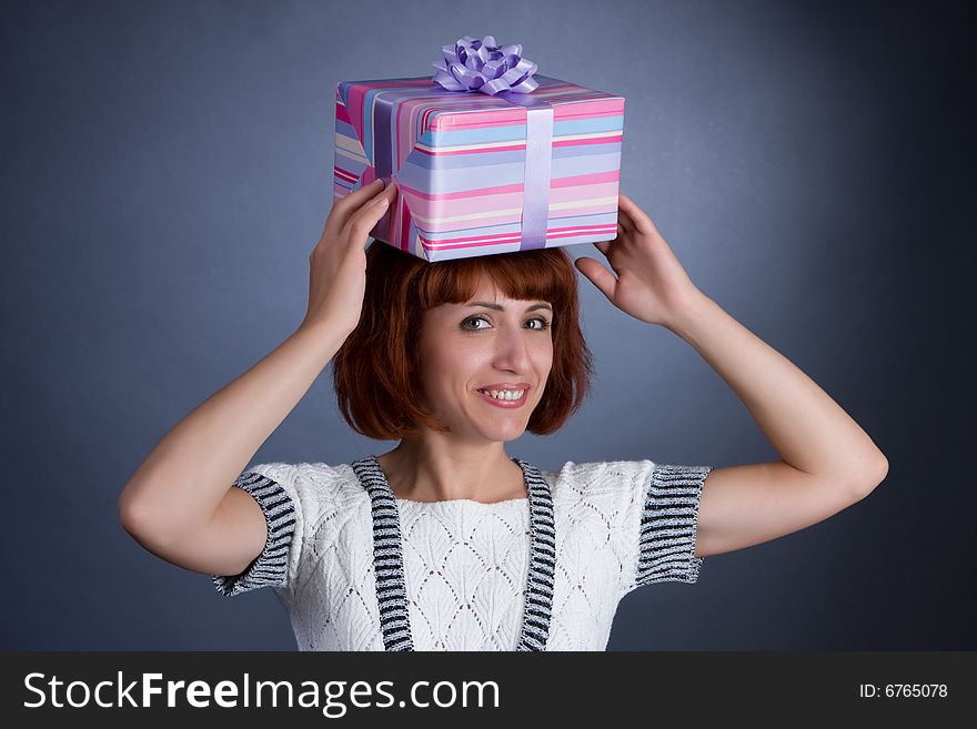 The beautiful Girl with a box of gifts on a head