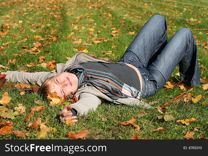 Beautiful blond young woman in autumn park