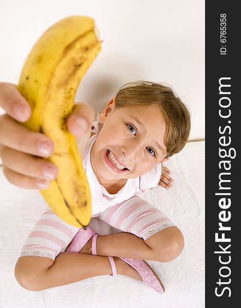 A little girl showing you banana