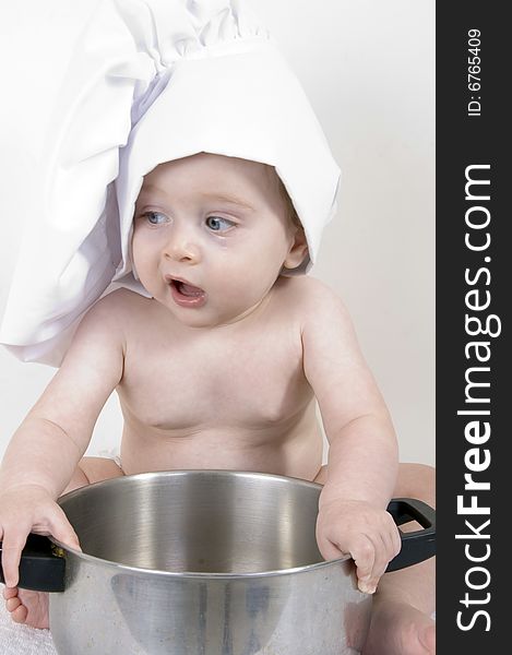 Little cute baby chef holding pan. Little cute baby chef holding pan