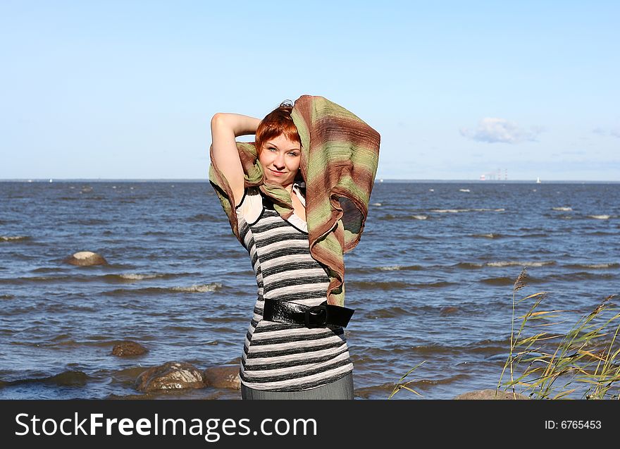 Red haired woman with scarf. Windy day.