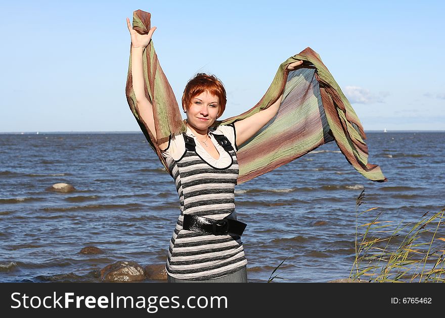 Red haired woman with scarf. Windy day.