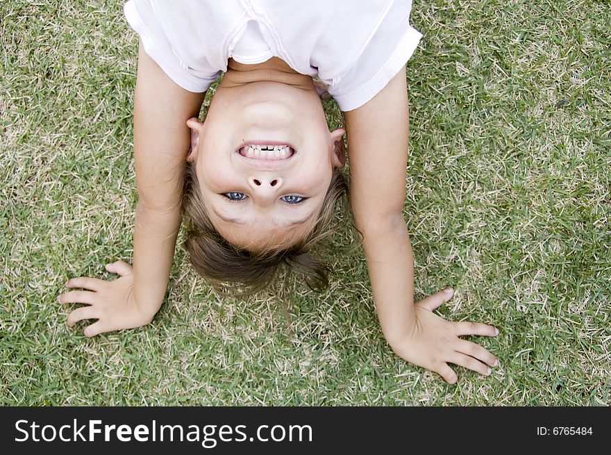 Young girl doing cartwheel on the grass. Young girl doing cartwheel on the grass