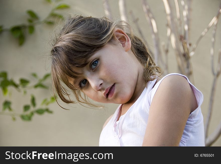 Adorable little girl posing in style on natural background