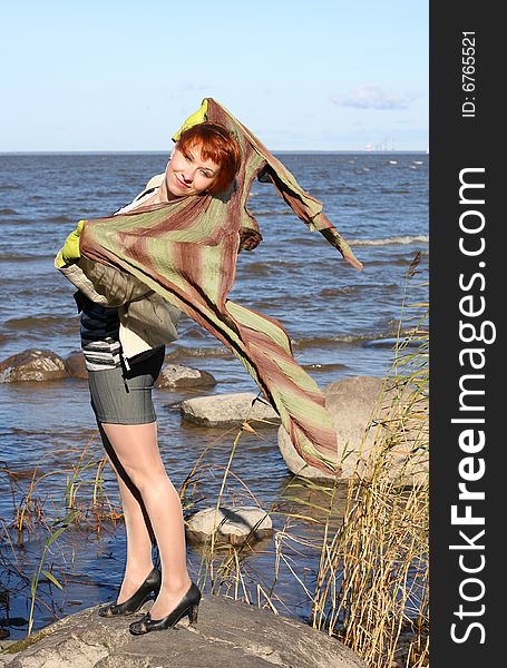 Red haired woman with scarf. Windy day.