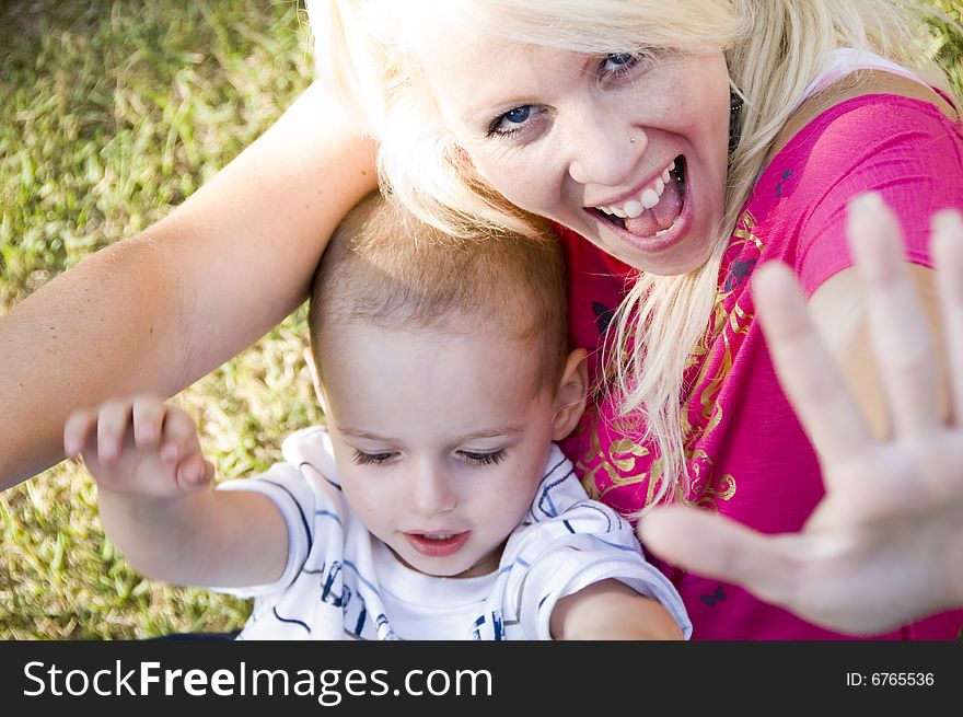 Cheerful Young Woman And Little Baby Sitting