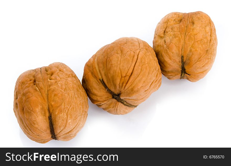 Three walnuts on white background