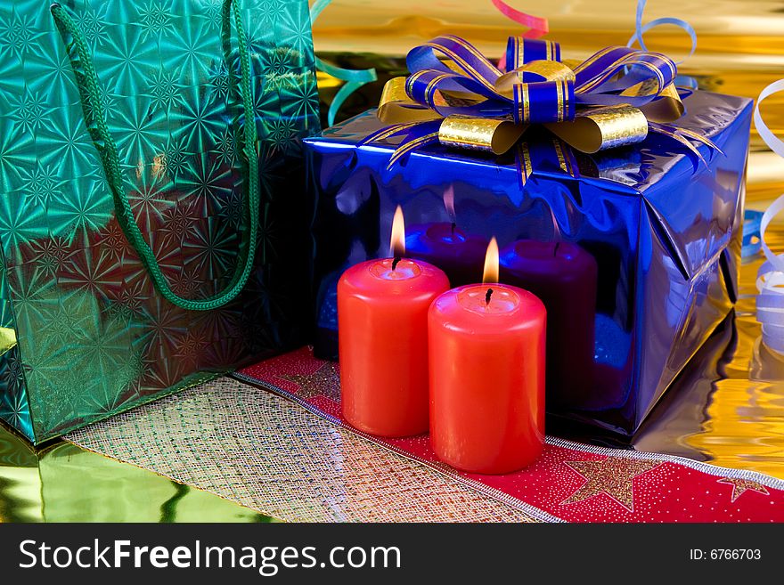 Blue gift box and red burning candles. Blue gift box and red burning candles
