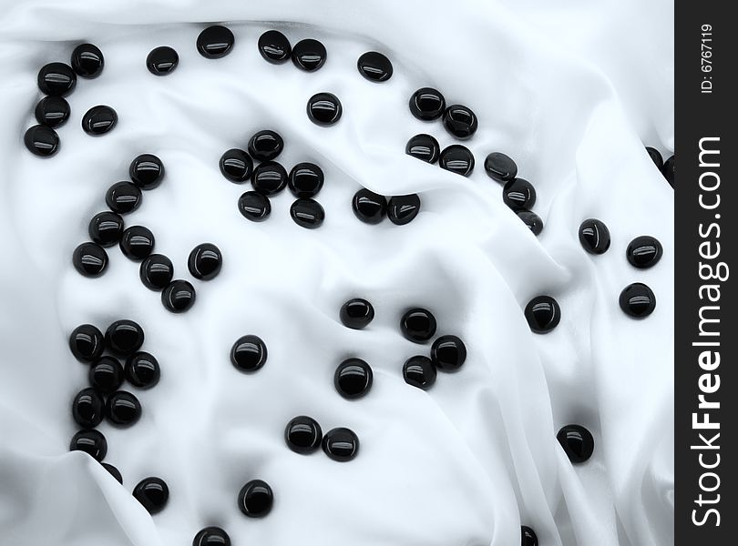 Black stones on white silk