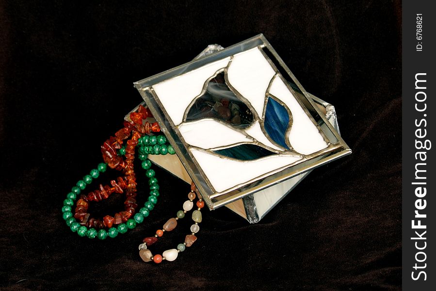 Necklaces of precious stones in the stained glass box. Necklaces of precious stones in the stained glass box