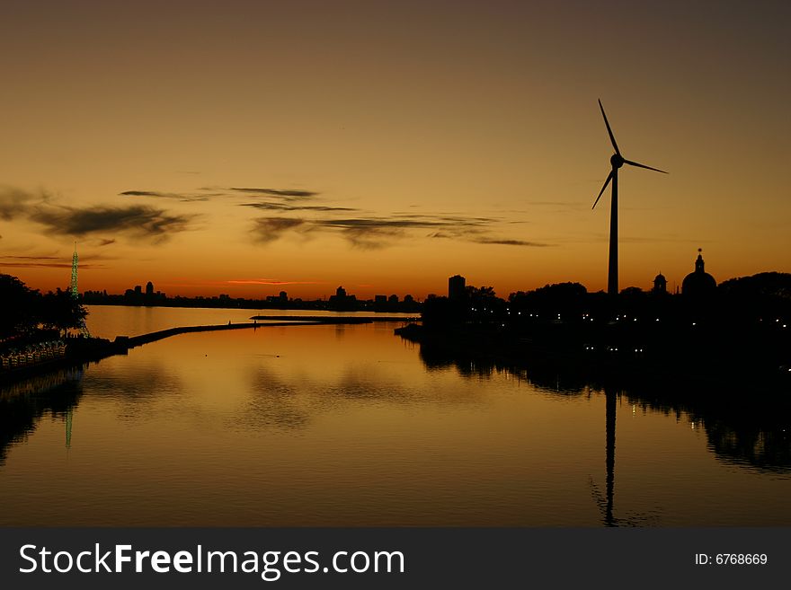 Sunset over water with windmill. Sunset over water with windmill