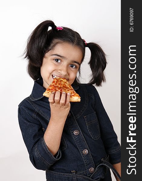 Girl eating pizza slice and smiling