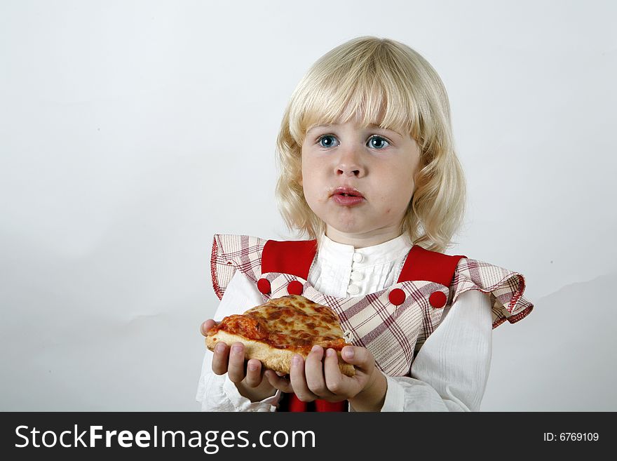 Sweet girl eating pizza slice