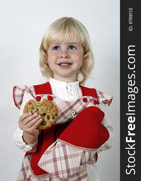 Sweet girl eating chocolate chip cookie. Sweet girl eating chocolate chip cookie