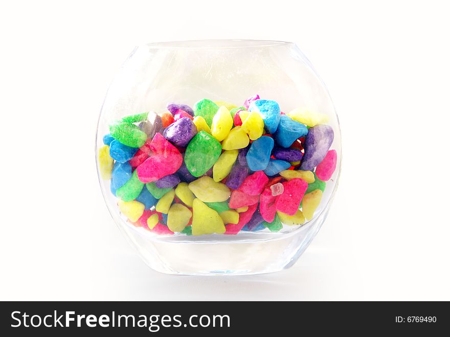 Various color of pebbles were put in a glass jar. Various color of pebbles were put in a glass jar