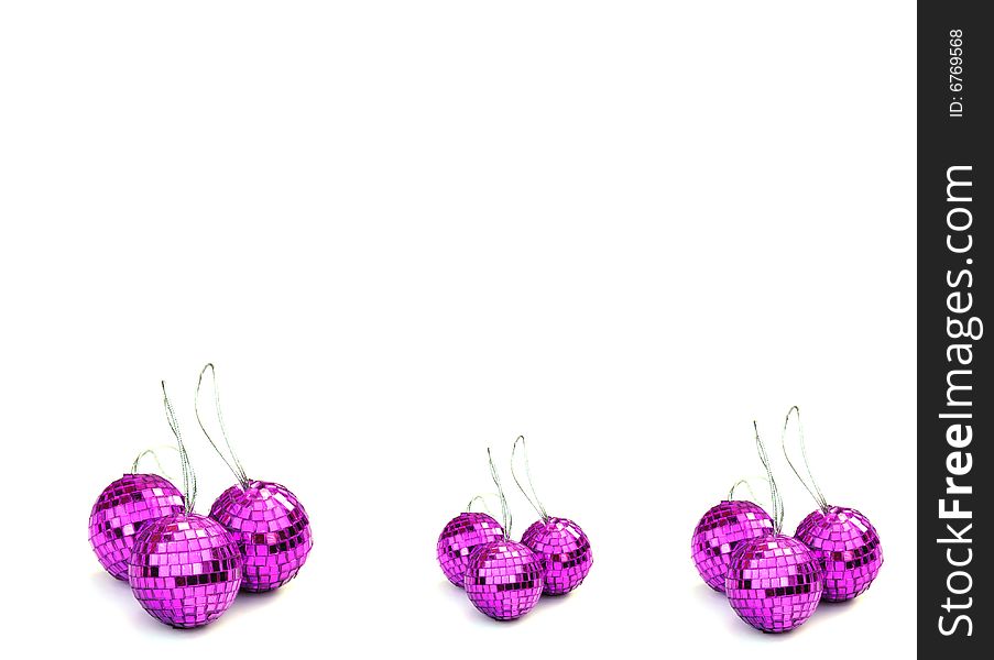 Pink christmas baubles on a white background