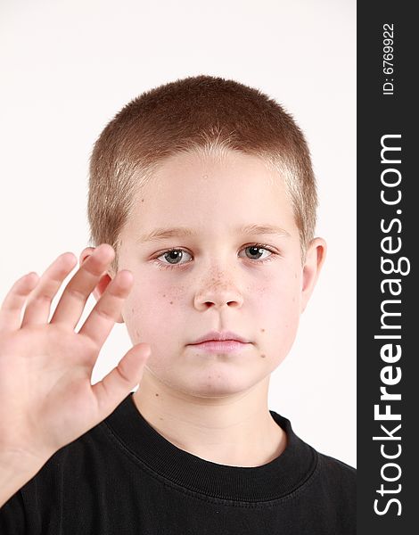Young boy is preparing to say good bye. On white background. Young boy is preparing to say good bye. On white background