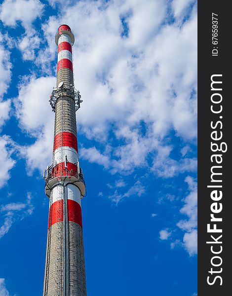 Monumental chimney on the blue sky background. Monumental chimney on the blue sky background