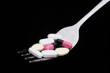 Pills On A Fork Royalty Free Stock Photos