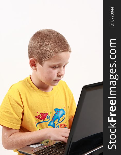 Young boy is working with his laptop - on white background. Young boy is working with his laptop - on white background