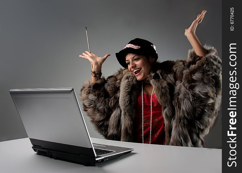 woman with fur and laptop. woman with fur and laptop