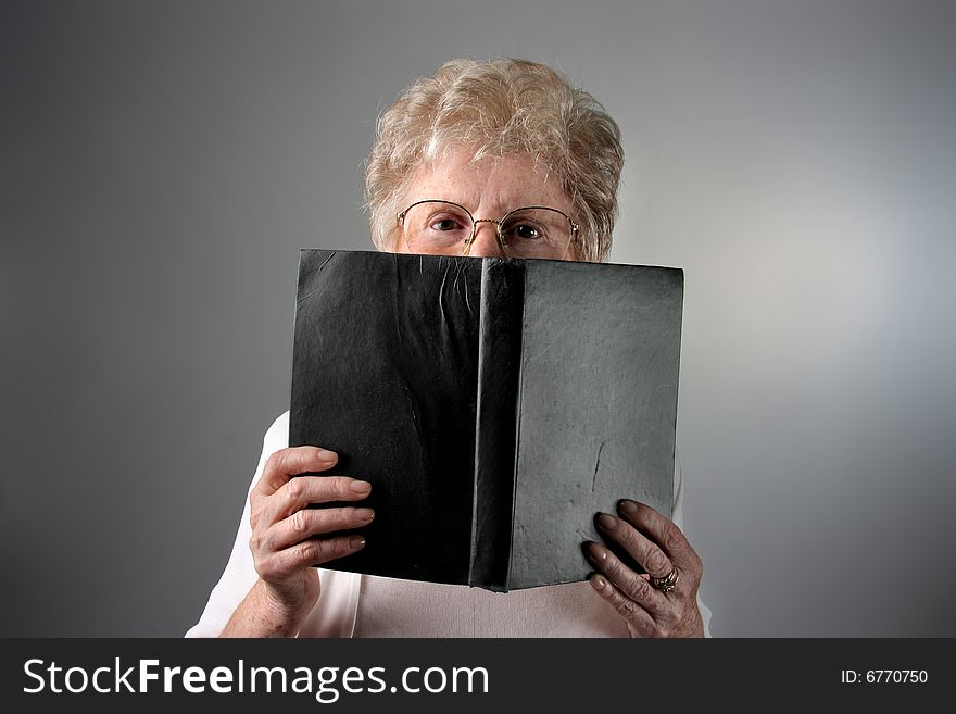 a senior woman with a book. a senior woman with a book