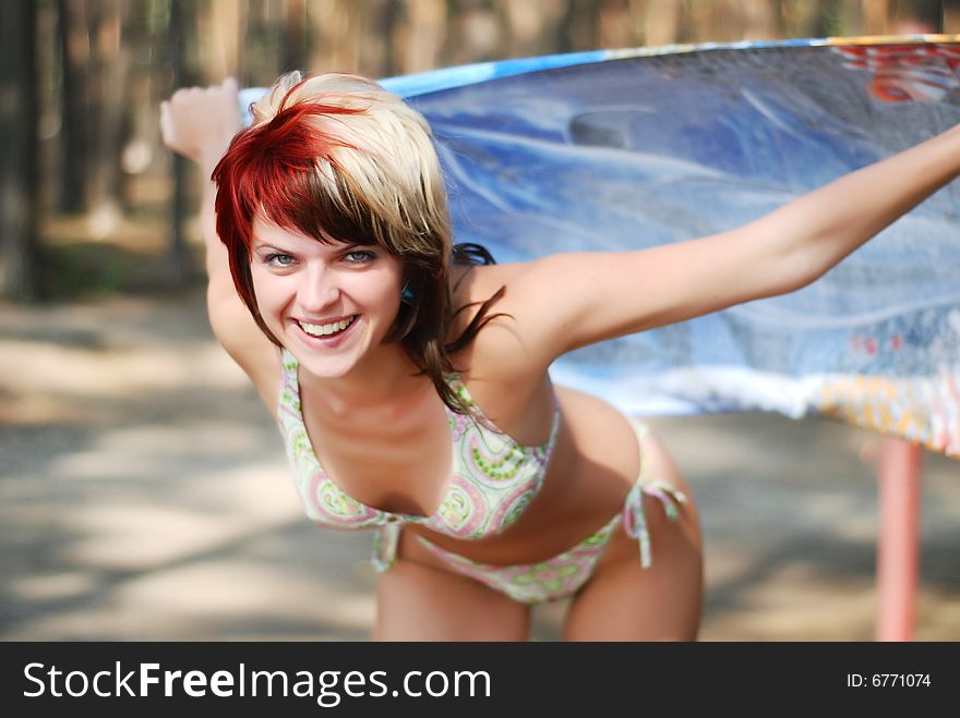 Portrait of young happy woman in bikini with blue shal. Portrait of young happy woman in bikini with blue shal