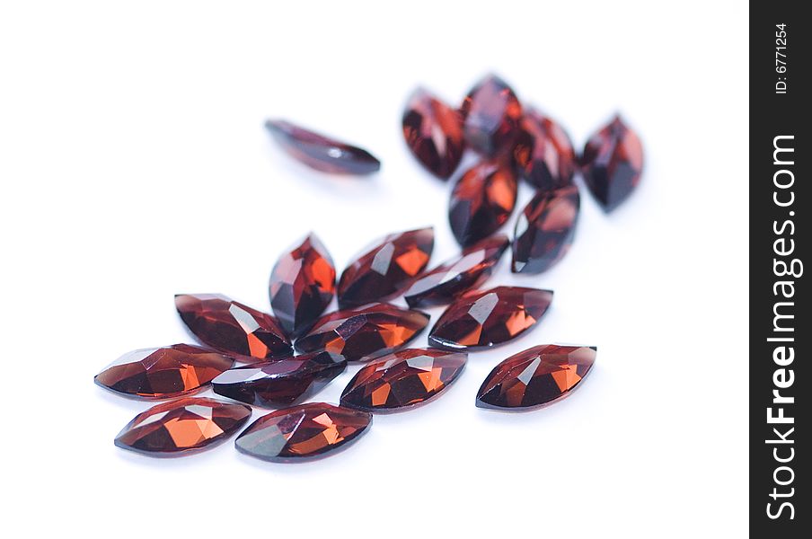 Garnets isolated on white background. Shallow depth of field with the nearest stones in focus.