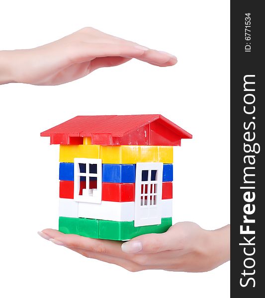 Toy colour plastic house with red roof in palms of young woman. Toy colour plastic house with red roof in palms of young woman