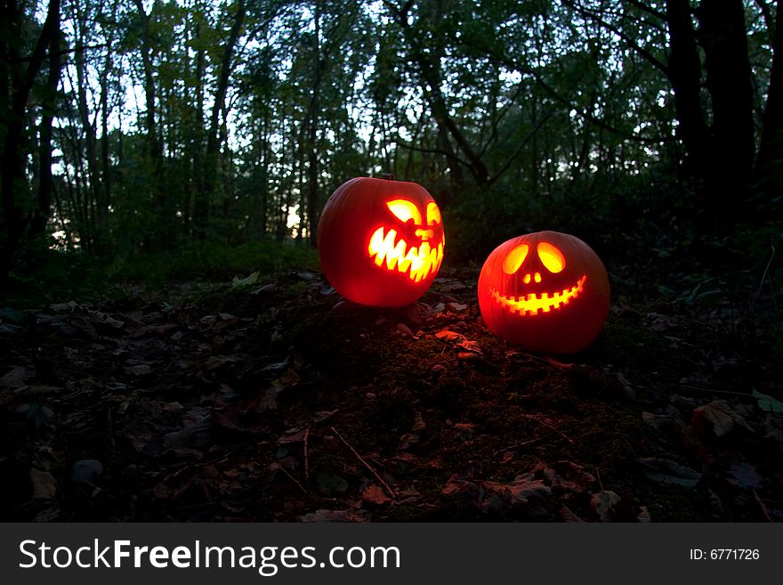 Spooky Halloween pumpkins in the woods