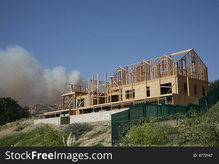 New home construcion with smoke from wildfires billowing nearby. October 13, 2008 Los Angeles, CA. New home construcion with smoke from wildfires billowing nearby. October 13, 2008 Los Angeles, CA