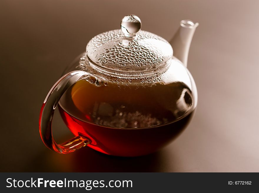 Glass teapot with black tea