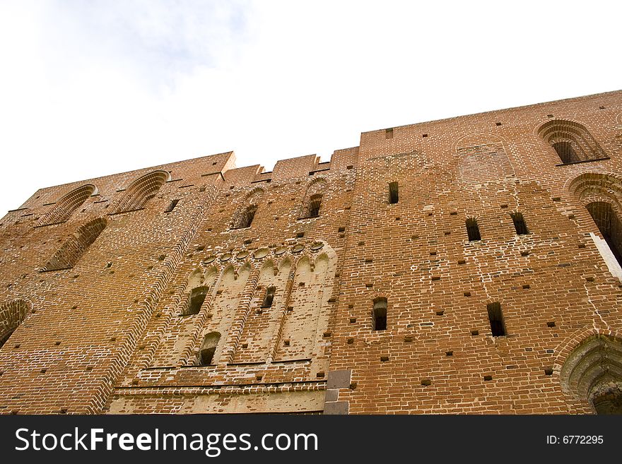 Ruined medieval castle in Latvia on a background of the blue sky