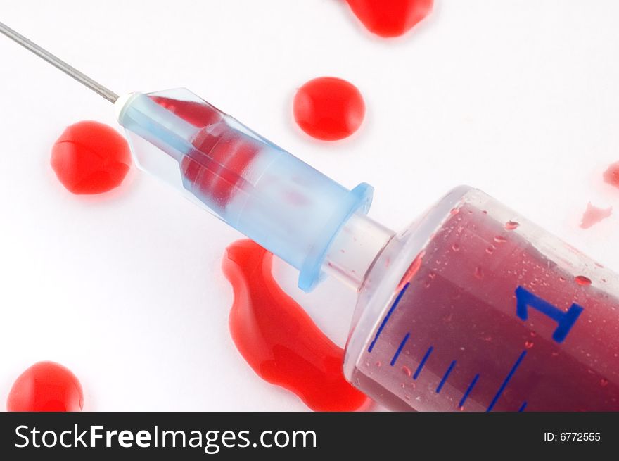 Close-up of a syringe with blood drops. Close-up of a syringe with blood drops