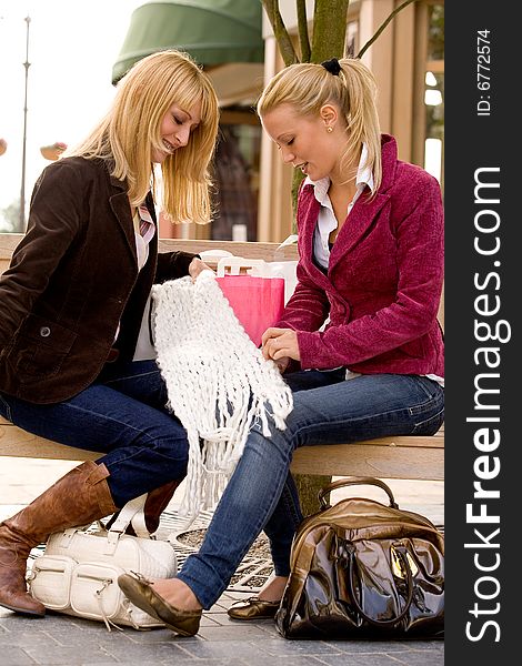 Two young girls shopping in the sunny weather. Two young girls shopping in the sunny weather