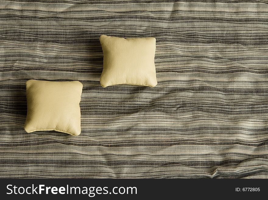 Two cushions on a striped background