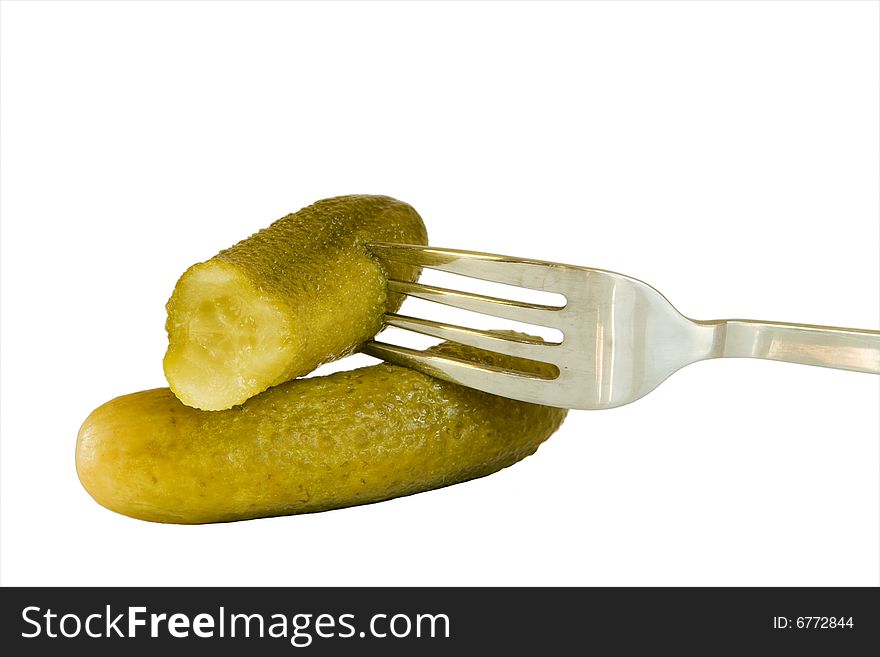 Isolated marinated cucumbers with the fork. Isolated marinated cucumbers with the fork
