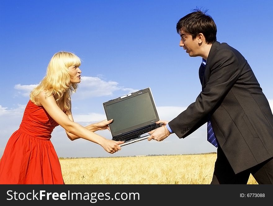 Businessman and lady in red fighting for notebook. Businessman and lady in red fighting for notebook